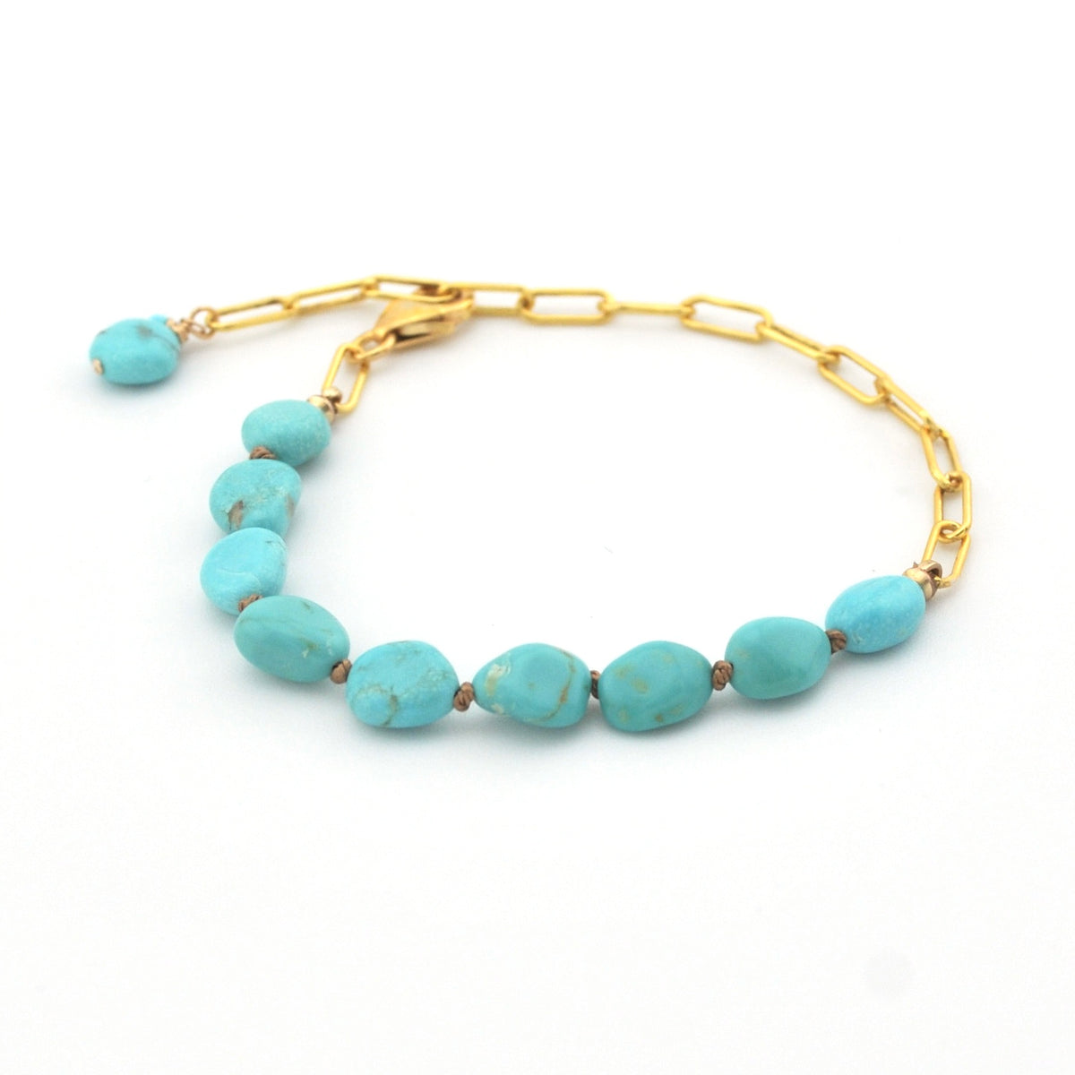 Turquoise beaded bracelet with gold chain on a white background