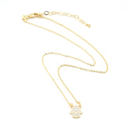 Gold necklace with a small pendant on a white background