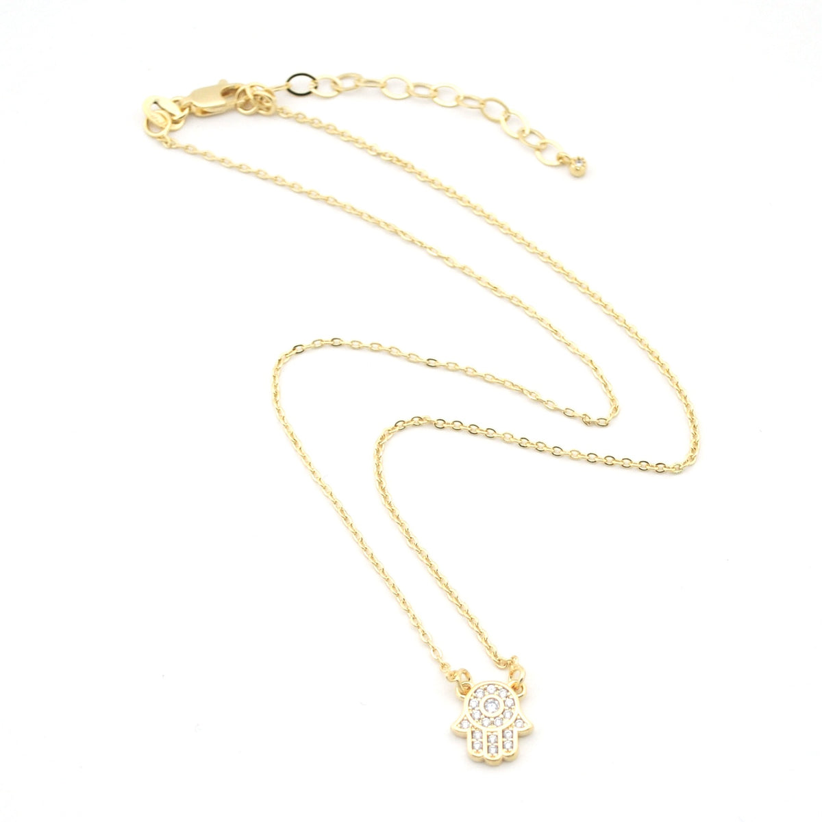 Gold necklace with a small pendant on a white background