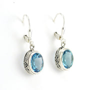 Side View Sterling Silver Blue Topaz 8x10mm Oval Bali Dangle Earrings