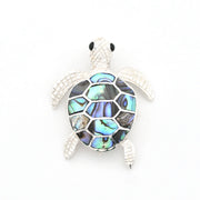 Tortoiseshell turtle brooch on a white background