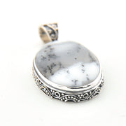 Pendant with white stone and silver border on a white background