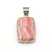 Pink stone pendant with silver setting on a white background