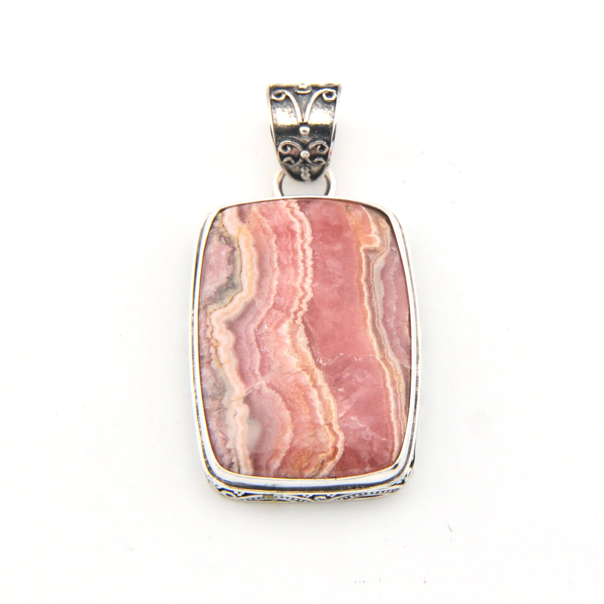 Pink stone pendant with silver setting on a white background