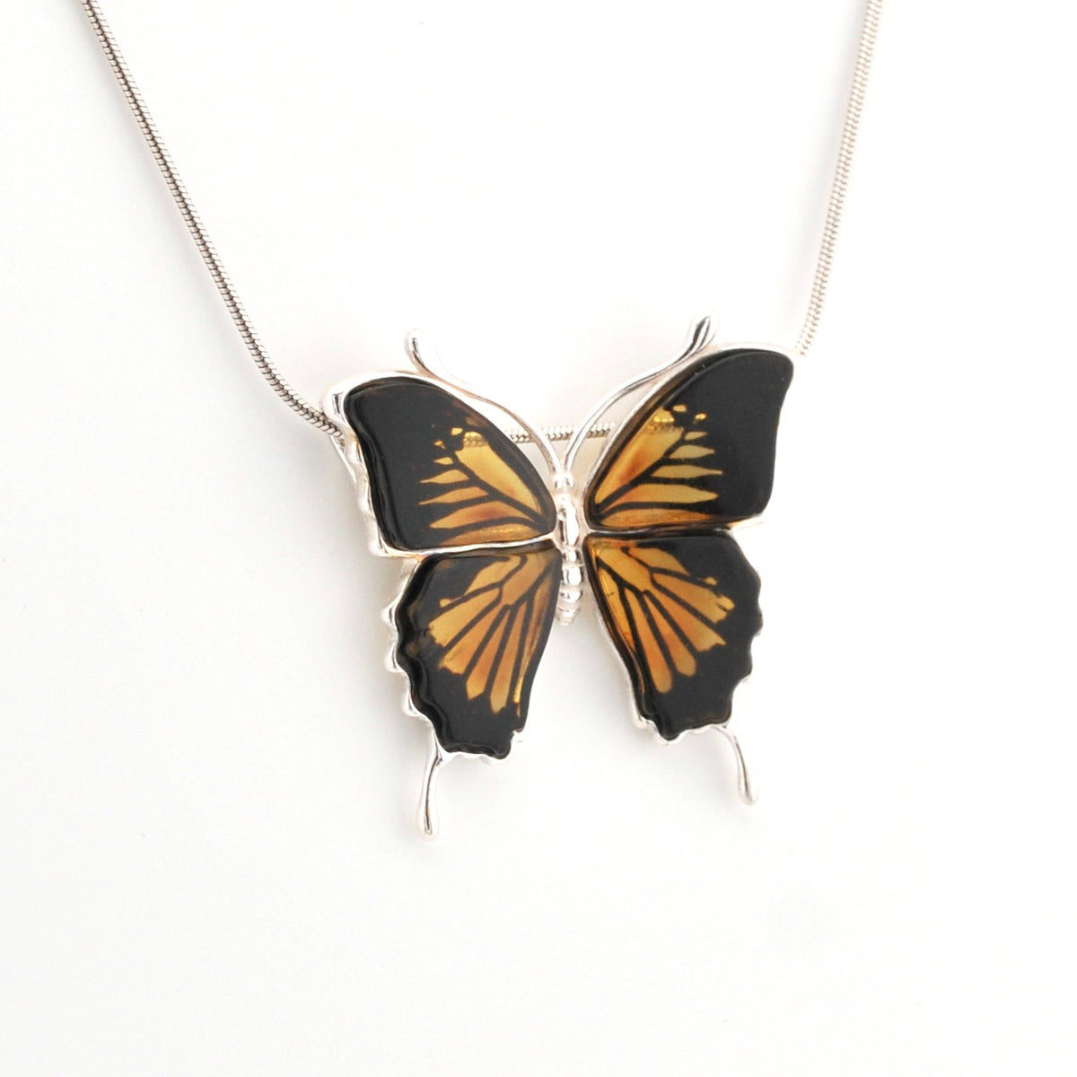 Butterfly-shaped pendant on a chain against a white background