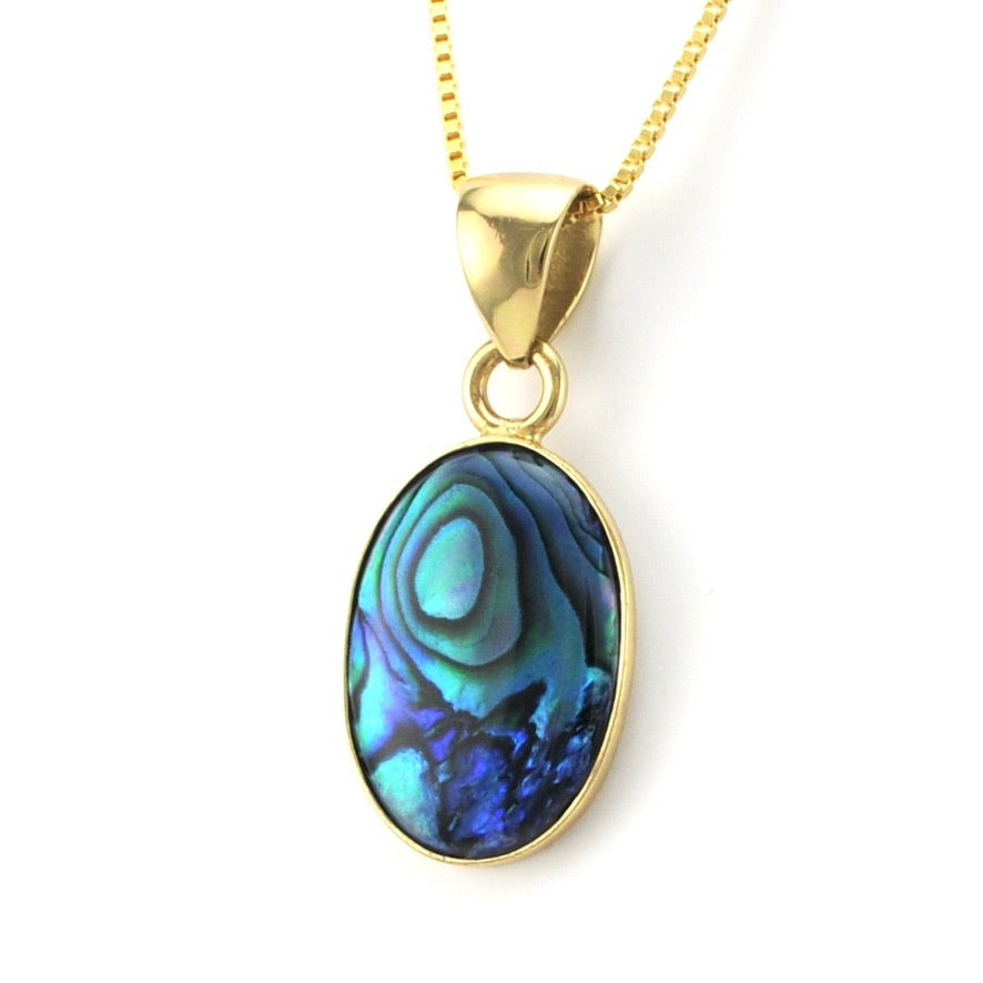 Gold necklace with a colorful pendant on a white background