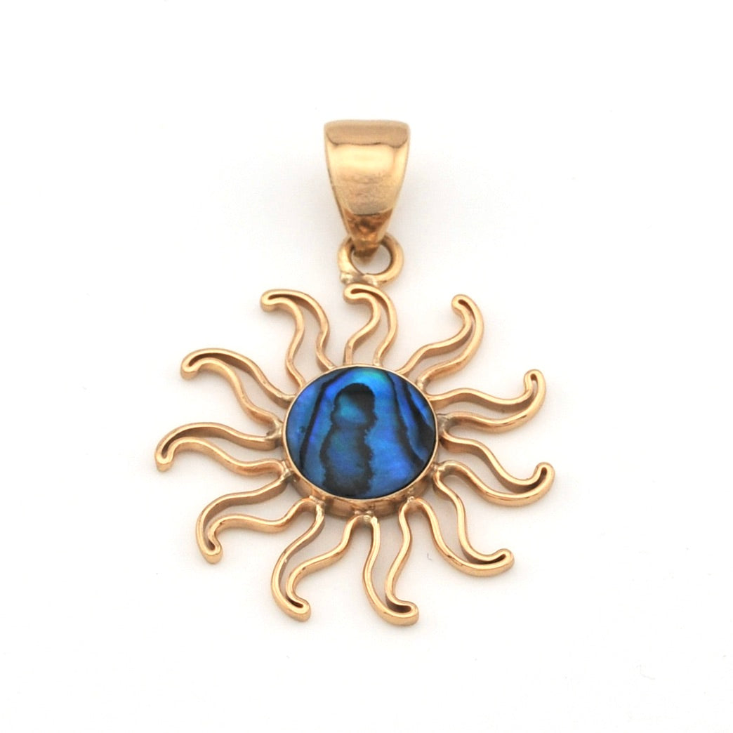 Gold sun-shaped pendant with a blue center on a white background
