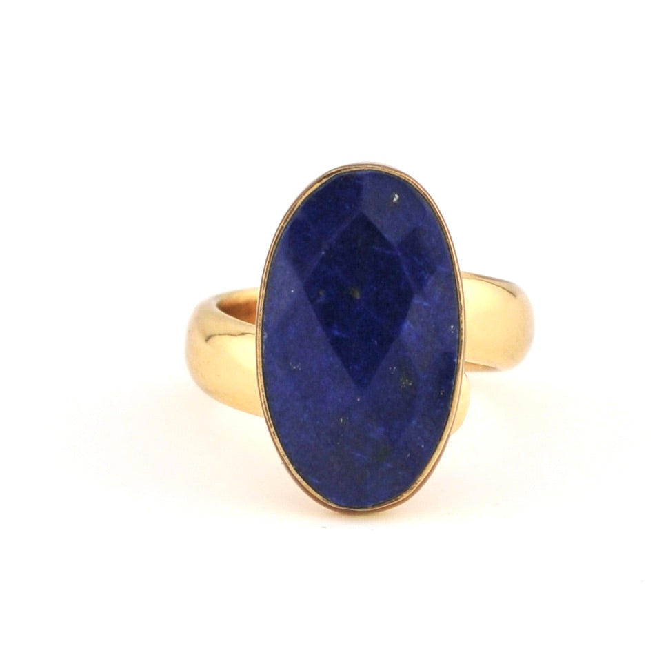 Gold ring with a blue stone on a white background
