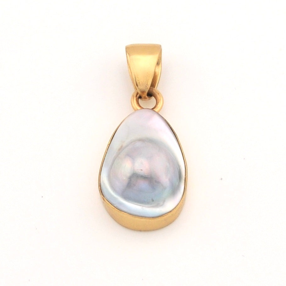 Gold pendant with a large pearl on a white background