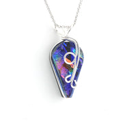 A silver wire-wrapped pendant necklace featuring a teardrop-shaped iridescent blue and purple glass with rainbow reflections, suspended from a delicate silver chain against a plain white background.