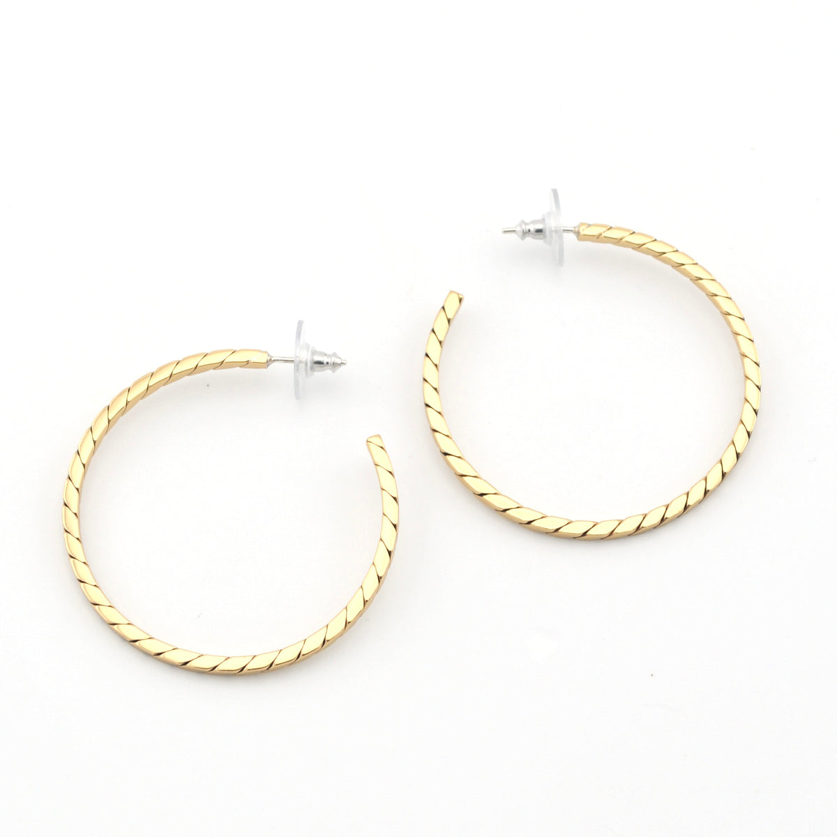Gold hoop earrings on a white background