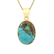 Turquoise pendant necklace on a gold chain against a white background
