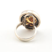 Silver ring with a sunflower design on a white background