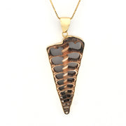 Gold and bronze pendant on a white background