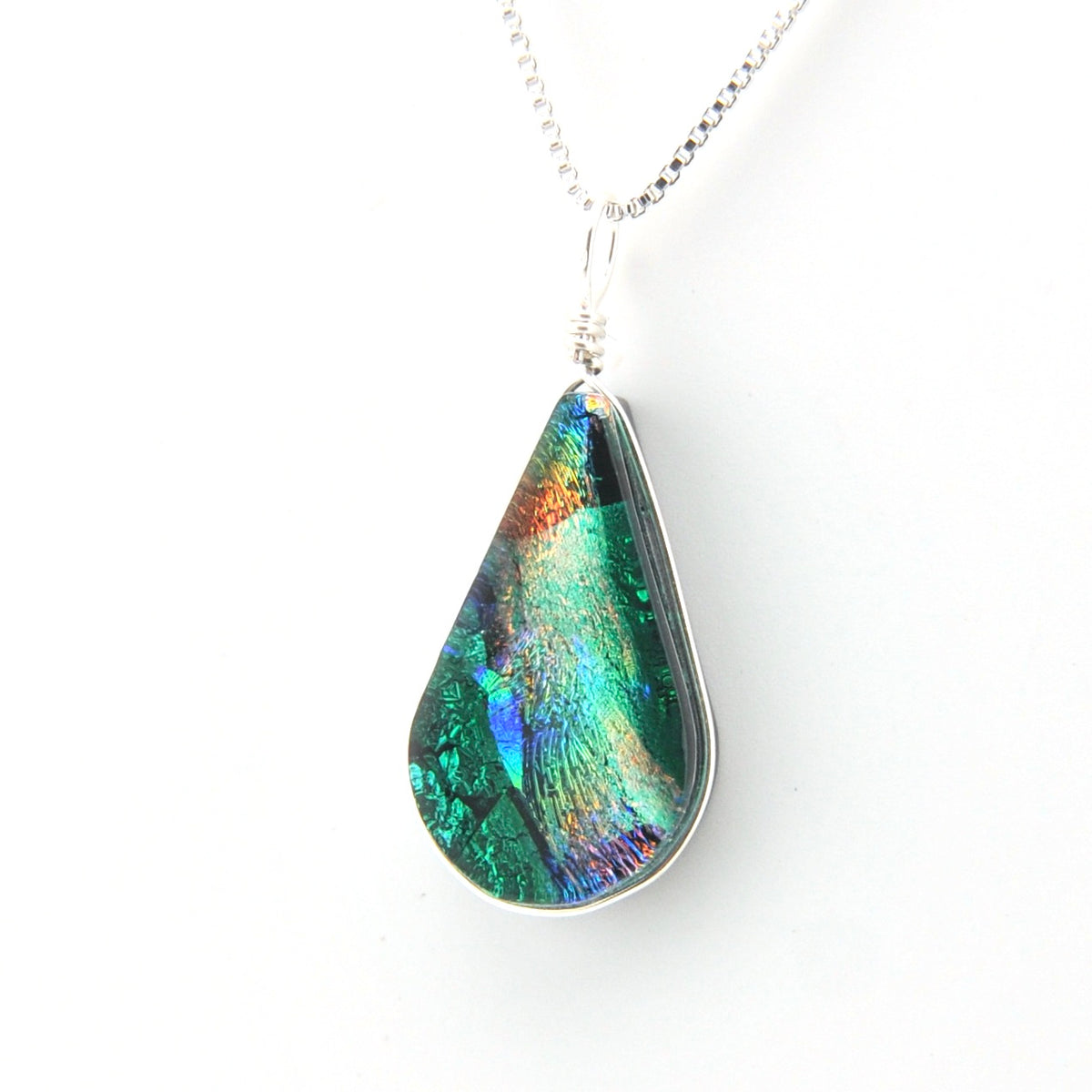 Teardrop-shaped pendant with multicolor design on a white background