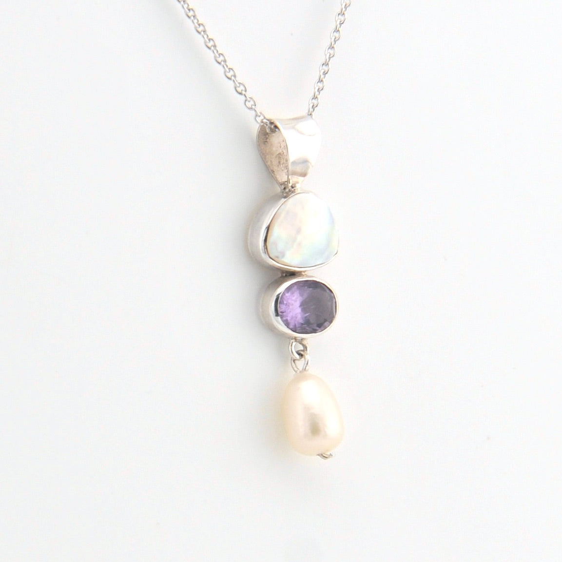 Necklace with three stones on a white background
