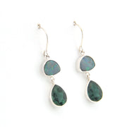 Pair of silver earrings with green gemstones on a white background