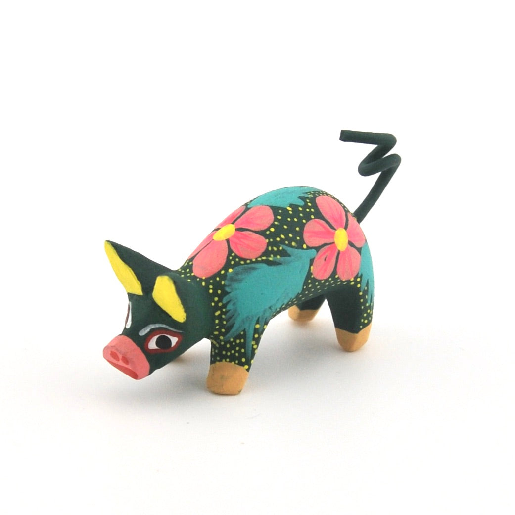 Colorful figurine of a creature with floral patterns on a white background