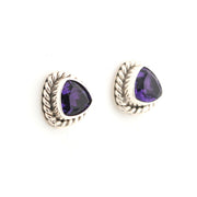 Pair of silver earrings with purple gemstones on a white background