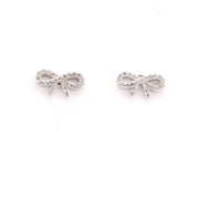 Silver bow-shaped earrings on a white background