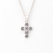 Silver cross pendant on chain.