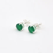 Green earrings with silver posts on a white background