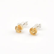 Pair of citrine stud earrings on a white background