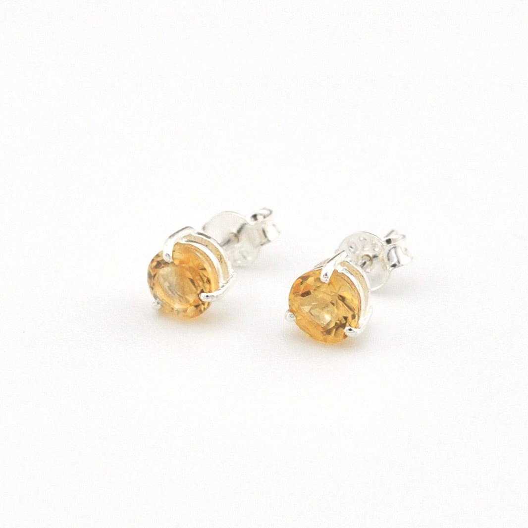 Pair of citrine stud earrings on a white background