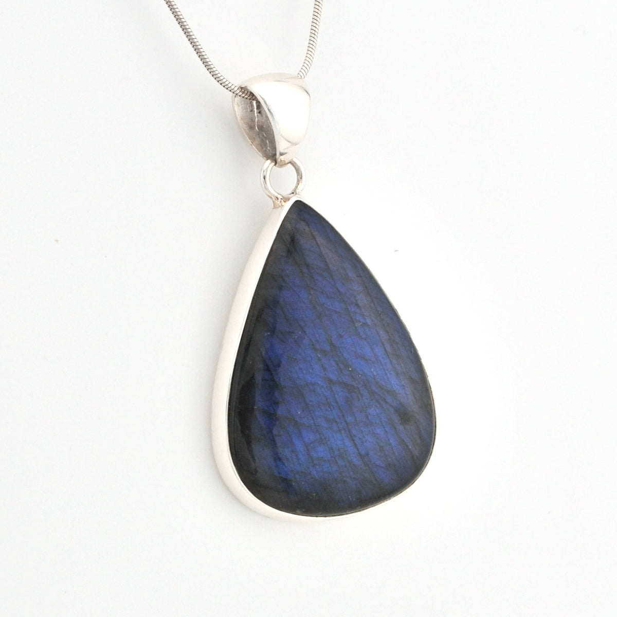 Teardrop-shaped blue pendant on a silver chain against a white background