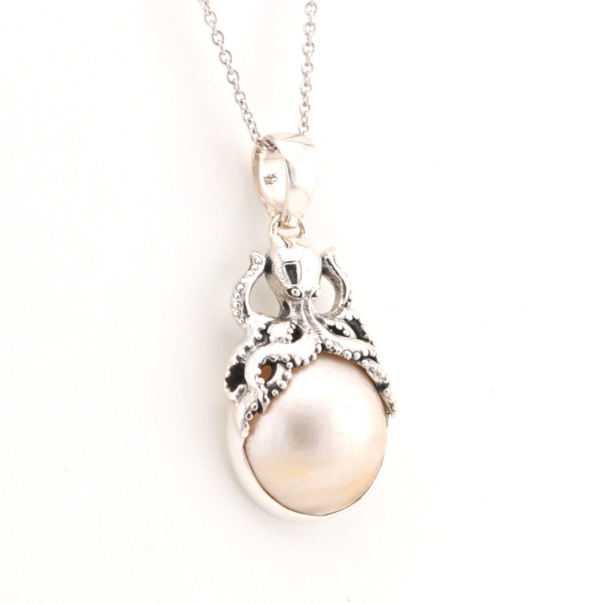 Pearl pendant necklace on a white background