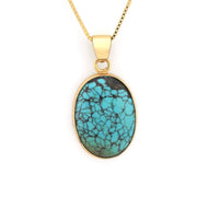 Turquoise pendant necklace on a gold chain against a white background