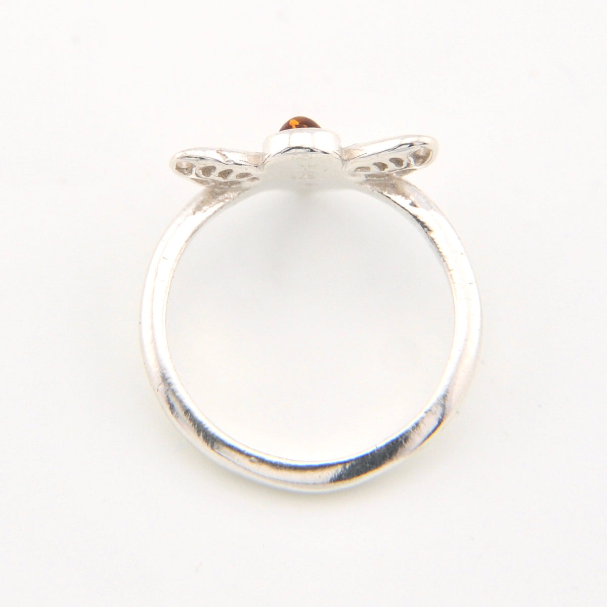 Silver ring with a small gemstone on a white background