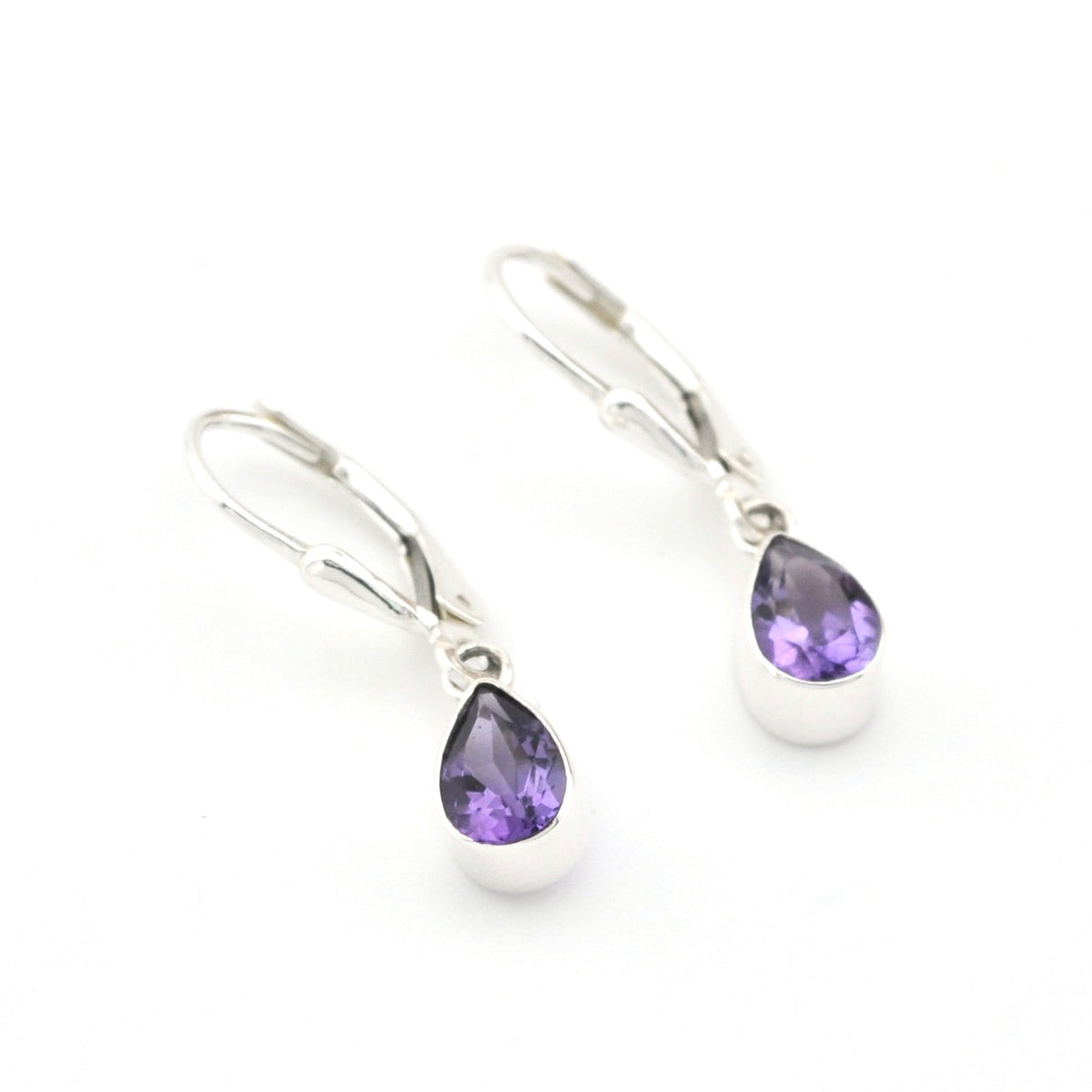 Silver earrings with purple teardrop gemstones on a white background