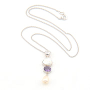 Necklace with a pendant featuring a purple gemstone and pearl on a white background