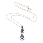 Silver necklace with purple gemstone pendant on a white background