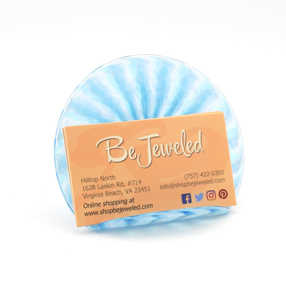 Round blue and white patterned card holder with 'Be Jeweled' business card on a white background