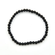 Black beaded bracelet on a white background