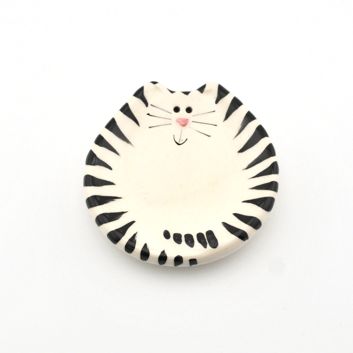 Round ceramic dish with a black and white striped cat design on a white background