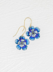 Blue flower-shaped earrings on a white background
