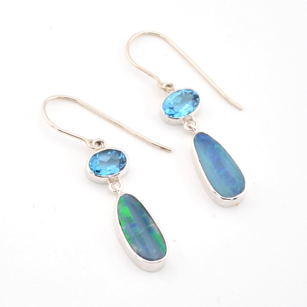 Pair of earrings with blue gemstones on a white background
