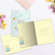 Open birthday card with candles illustration and envelope on a white background
