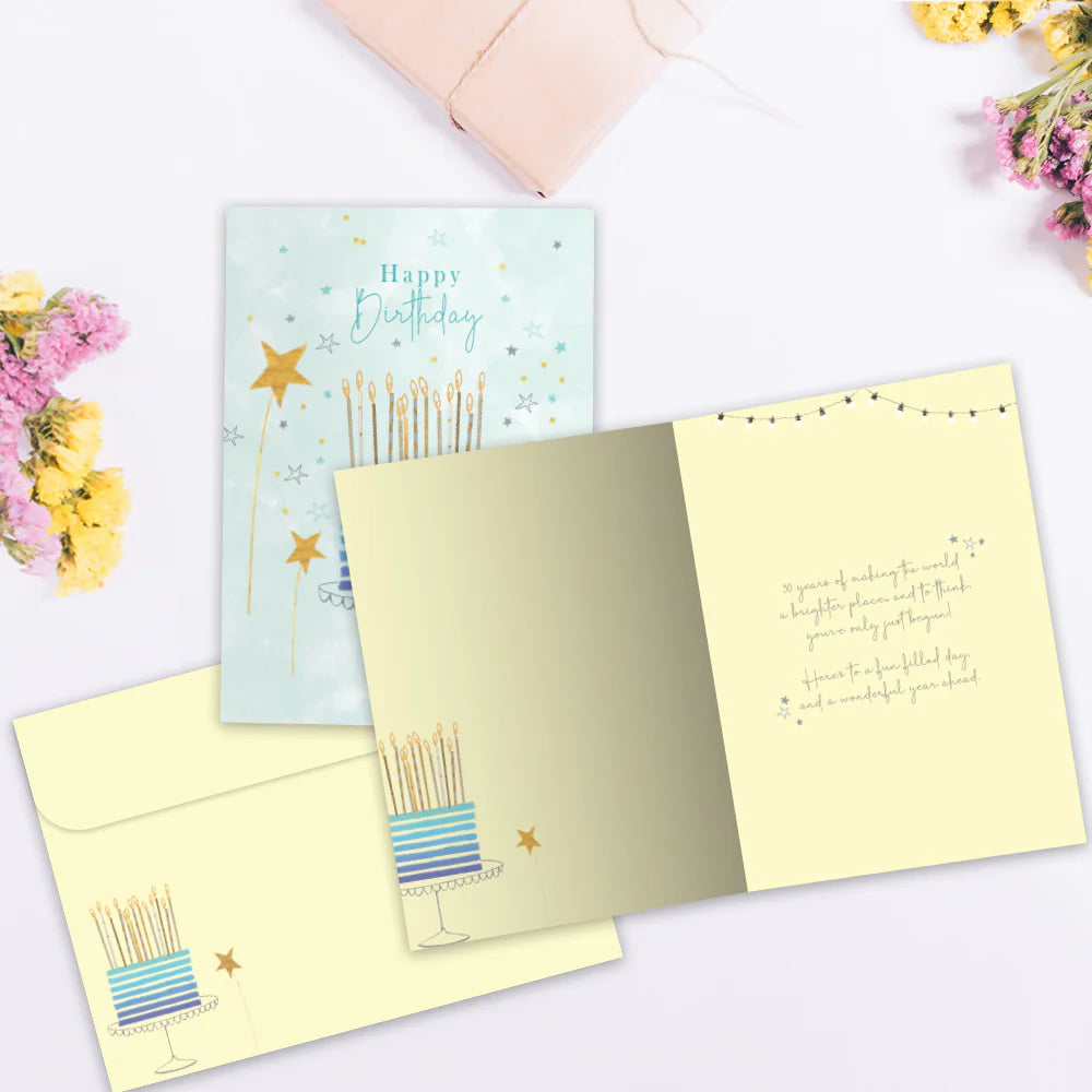 Open birthday card with candles illustration and envelope on a white background