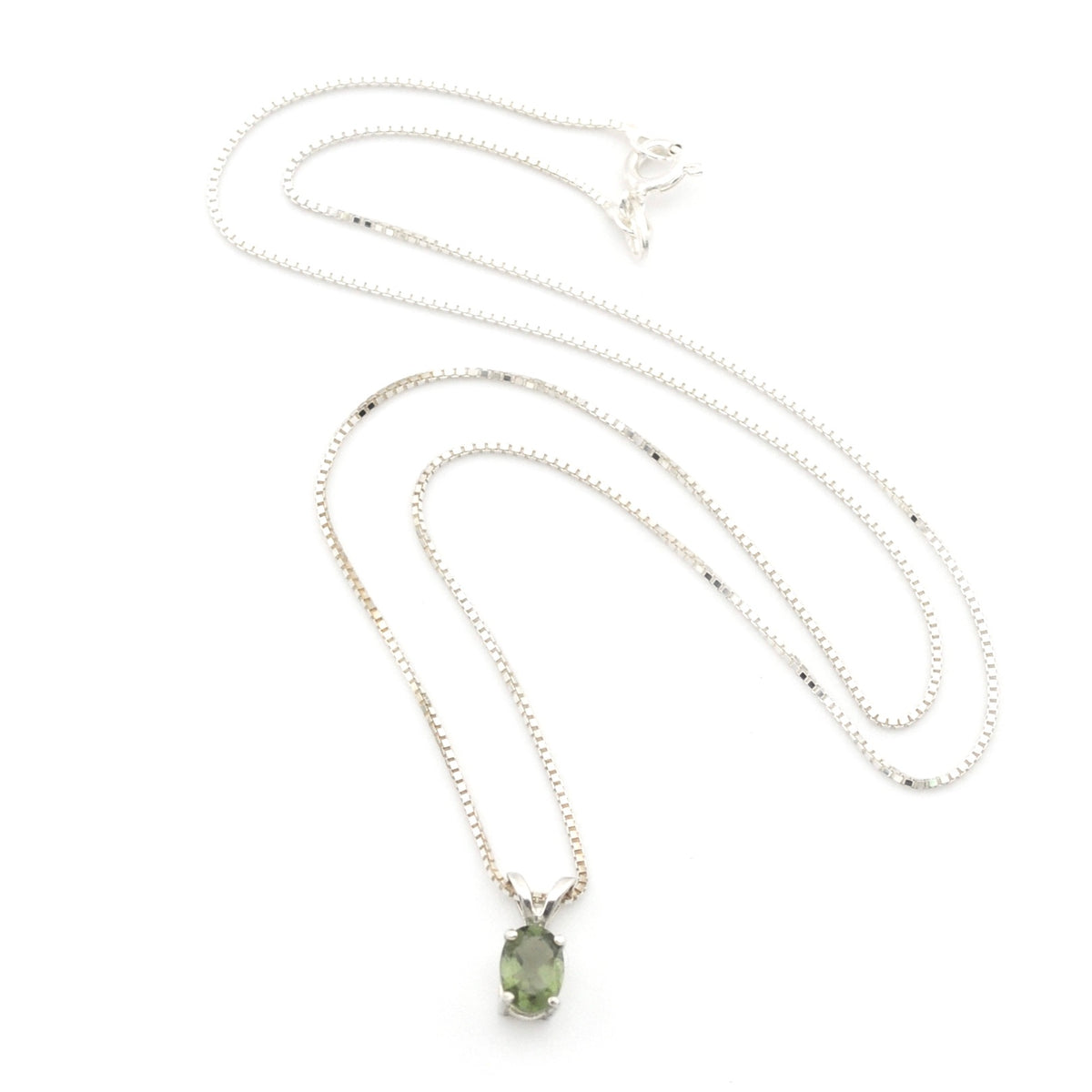 A silver chain necklace with a small oval green gemstone pendant, displayed on a clean white background.