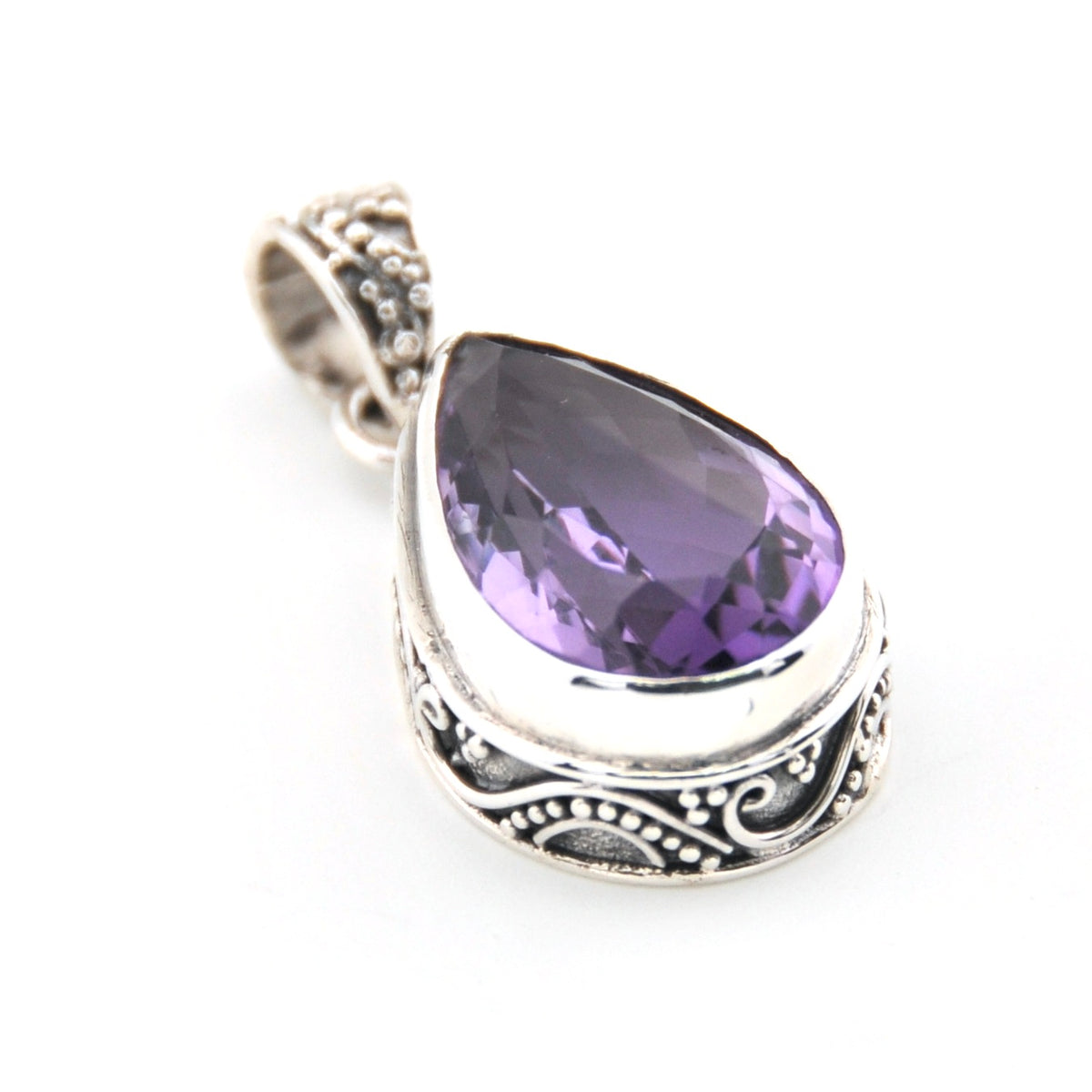 Purple teardrop pendant with silver setting on a white background