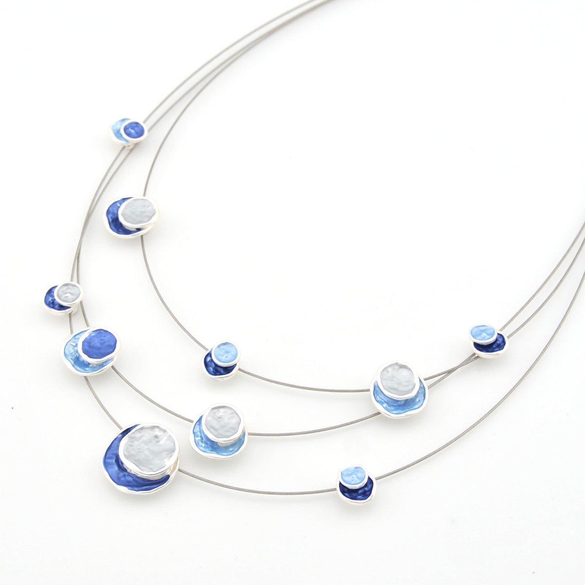 Necklace with blue and white circular pendants on a white background