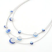 Necklace with blue and white circular pendants on a white background
