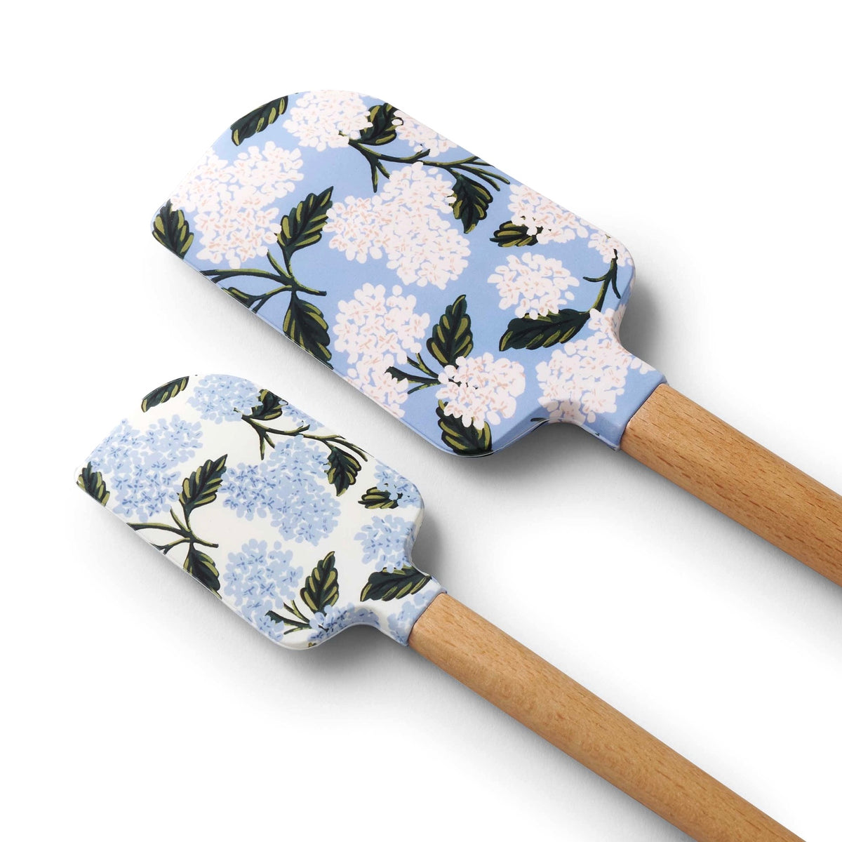 Two floral-patterned spatulas with wooden handles on a white background