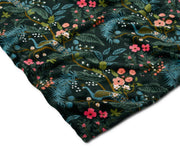 Fabric with a floral and bird pattern on a dark background