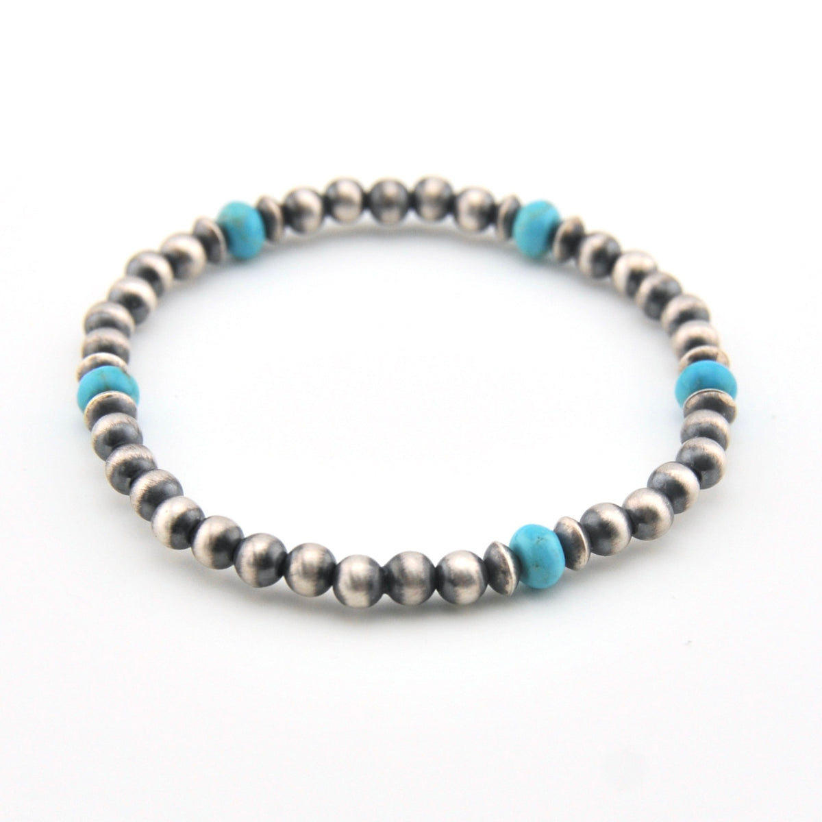 Silver beaded bracelet with blue accents on a white background