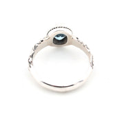 Silver ring with a dark gemstone on a white background